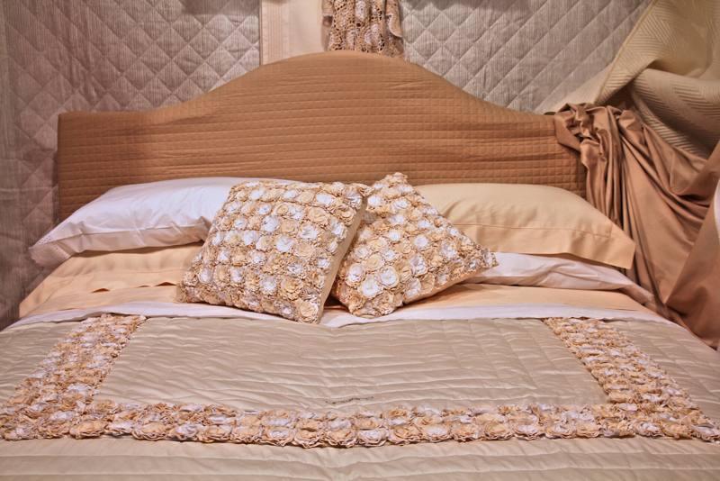 44 Made bed with richly decorated pillows and ornate bedspread.jpg